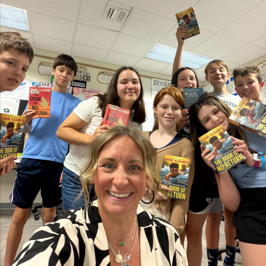 book-club_square Students and a faculty member hold up books