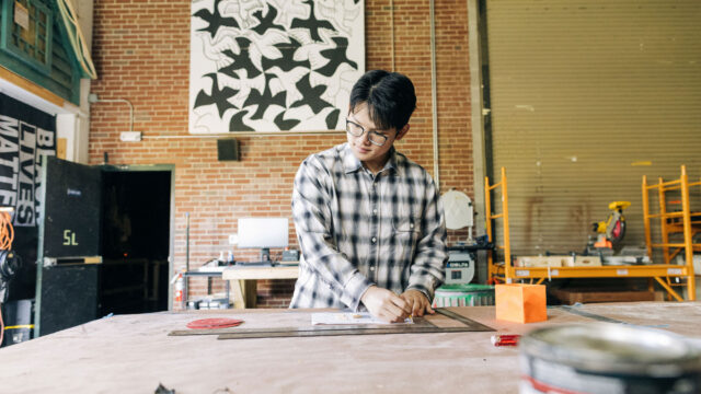 Student working in theater scene shop