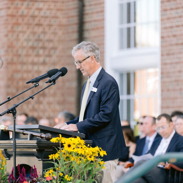 Man speaks at a microphone