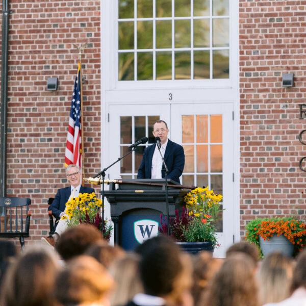 Man speaks at microphone