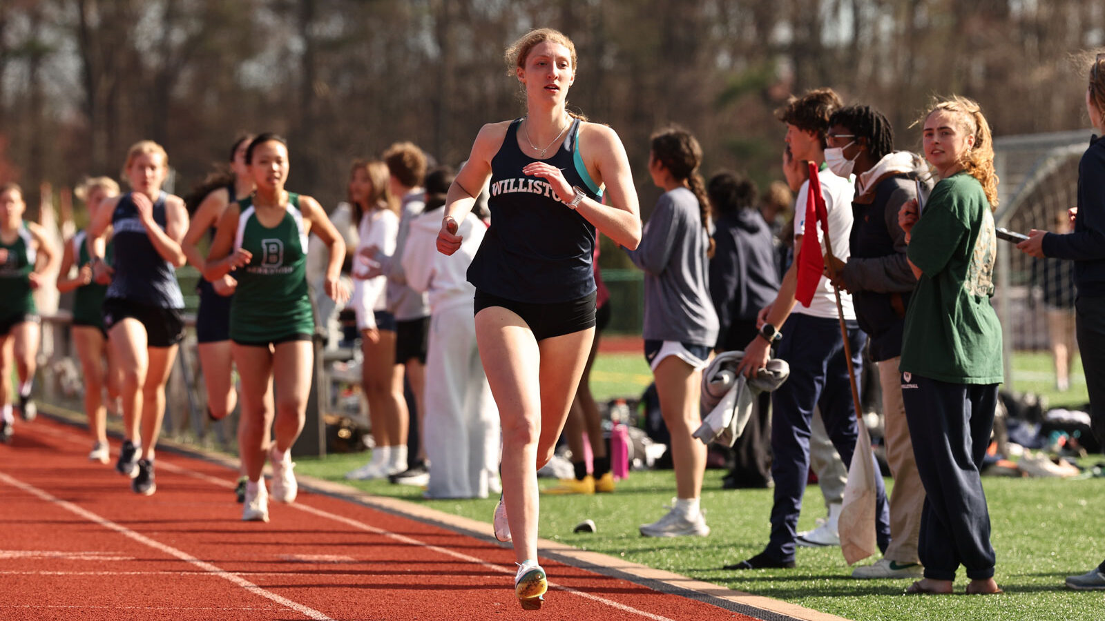 Female track athlete runs in a race