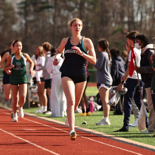 Female track athlete runs in a race