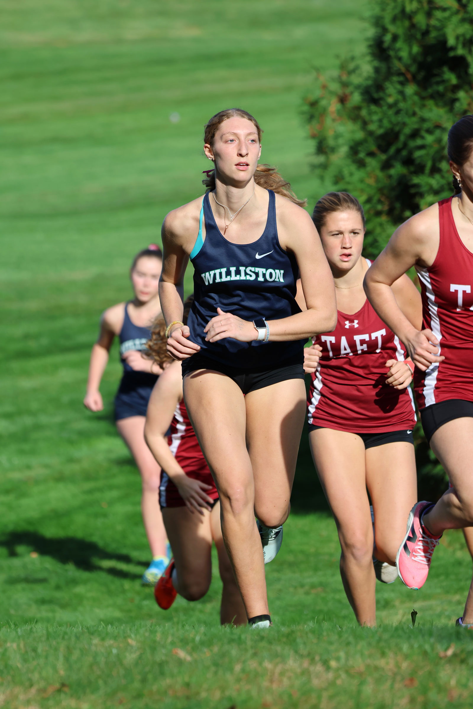 A female cross-country runner races
