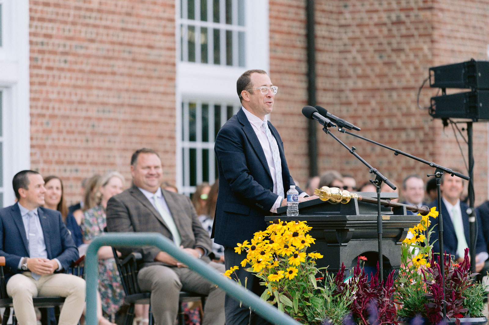 Man speaks at microphone