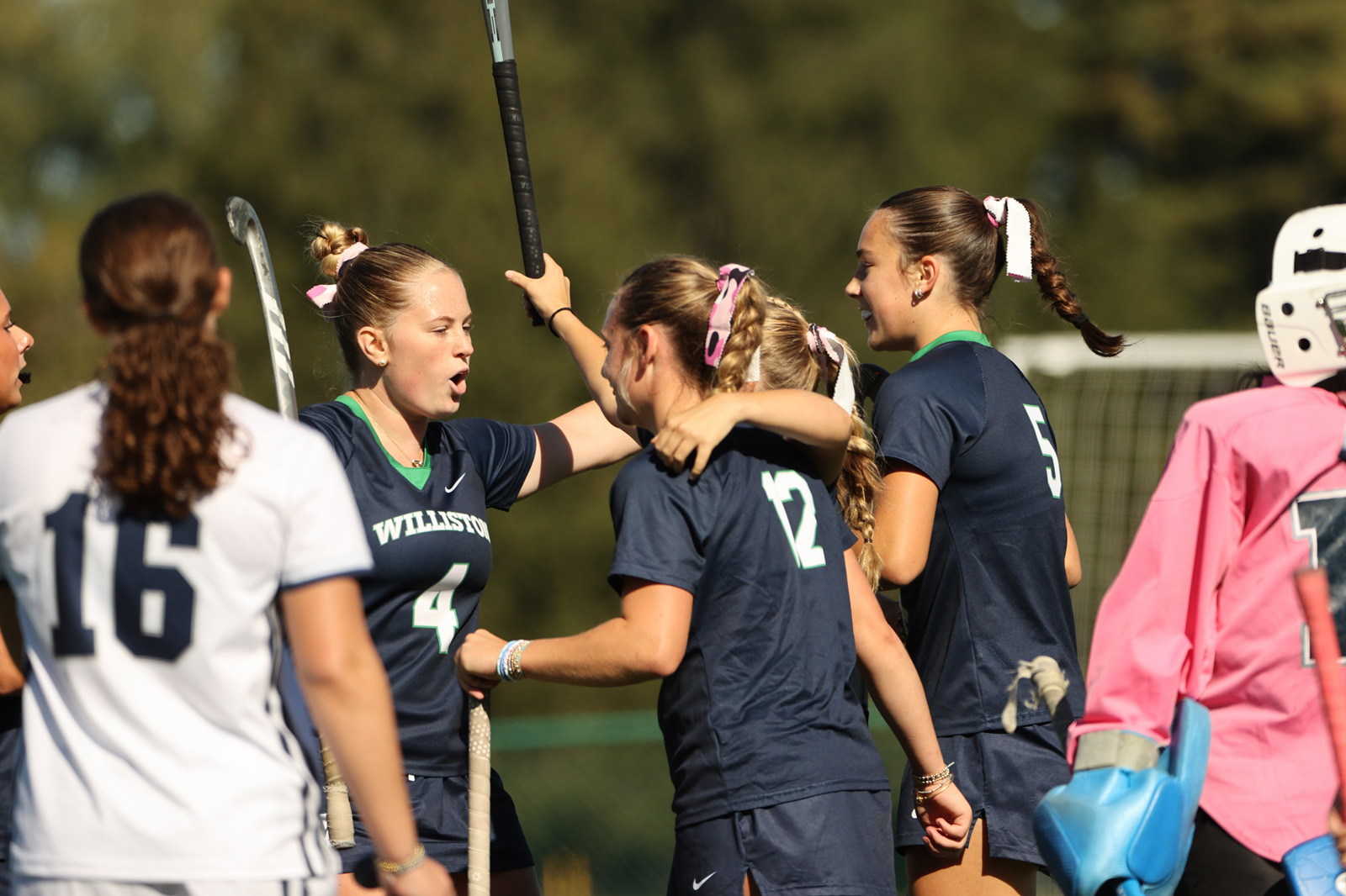 Members of the Williston field hockey team celebrate a goal