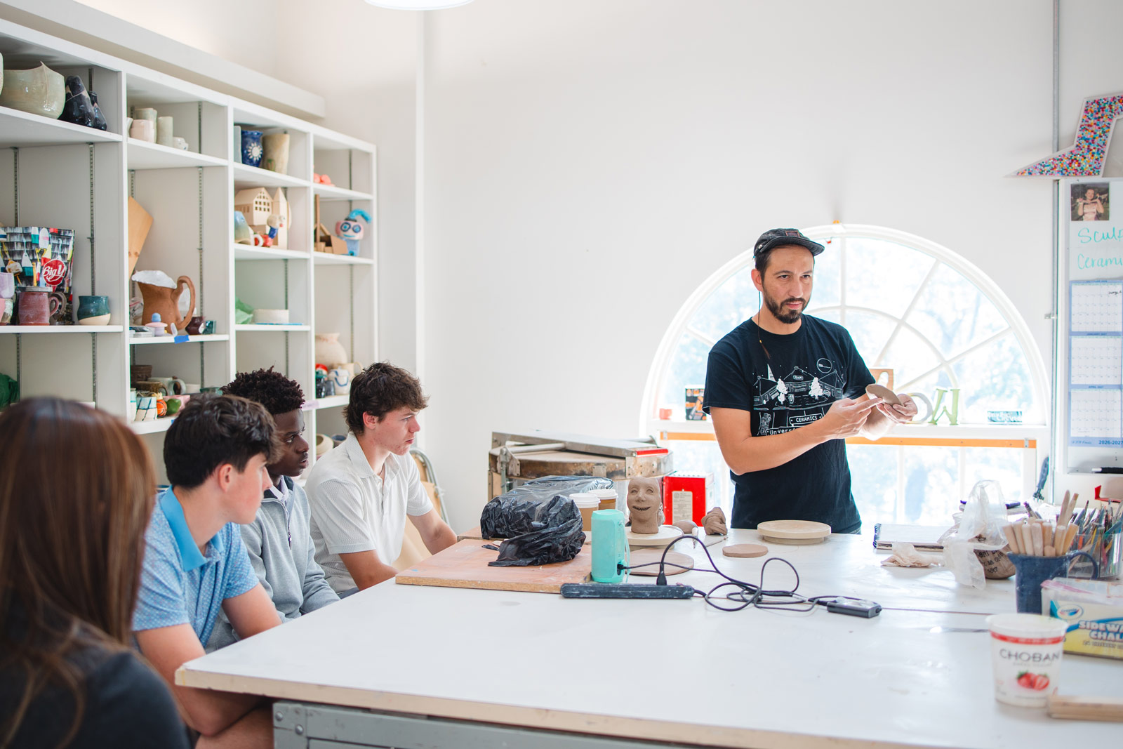 A Grum Project artist works with students during a class.