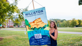 Girl holds up Class of 2027 banner