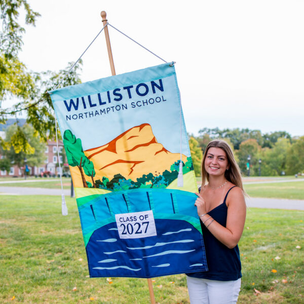 Girl holds up Class of 2027 banner