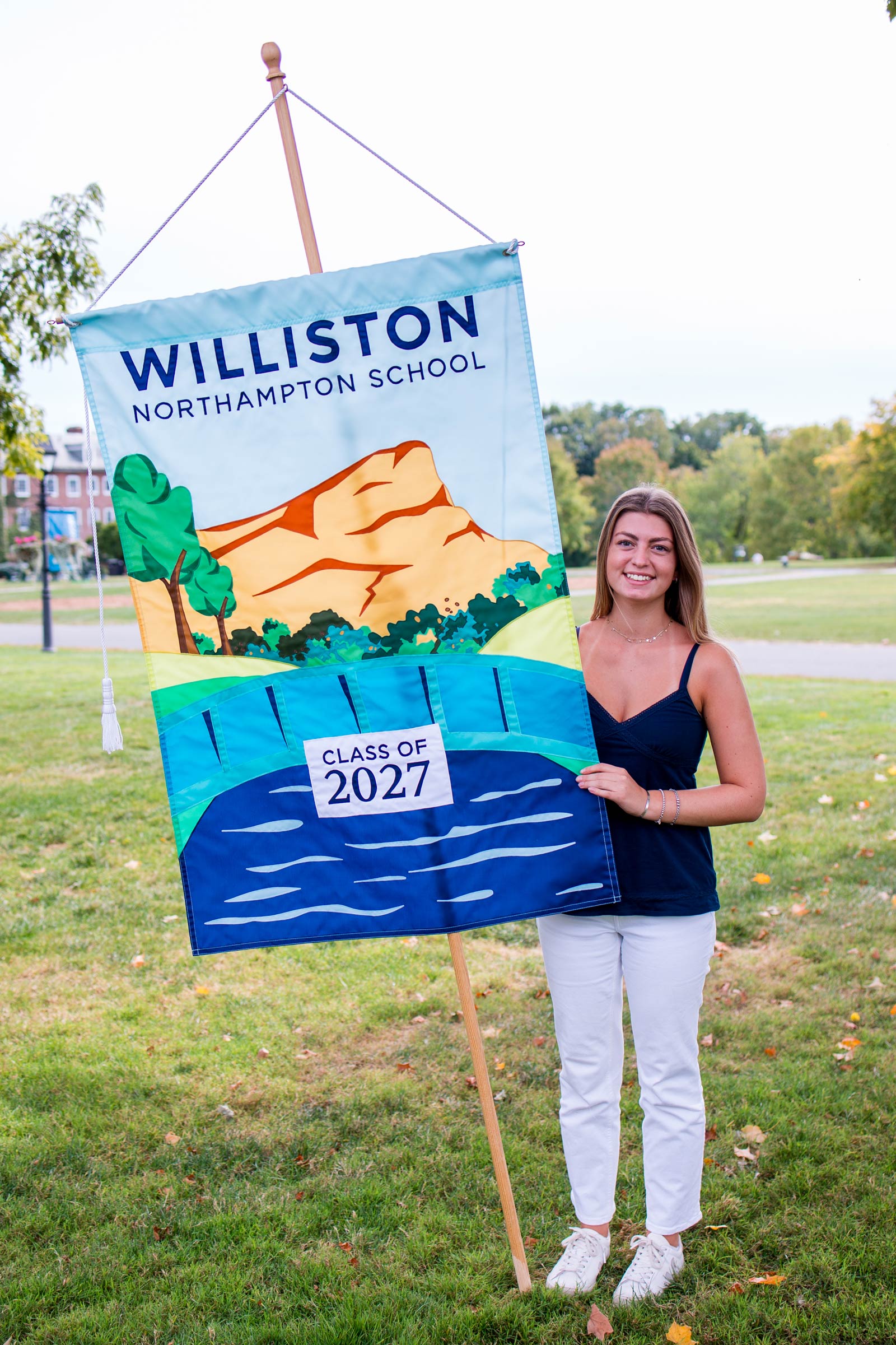 Girl holds up Class of 2027 banner