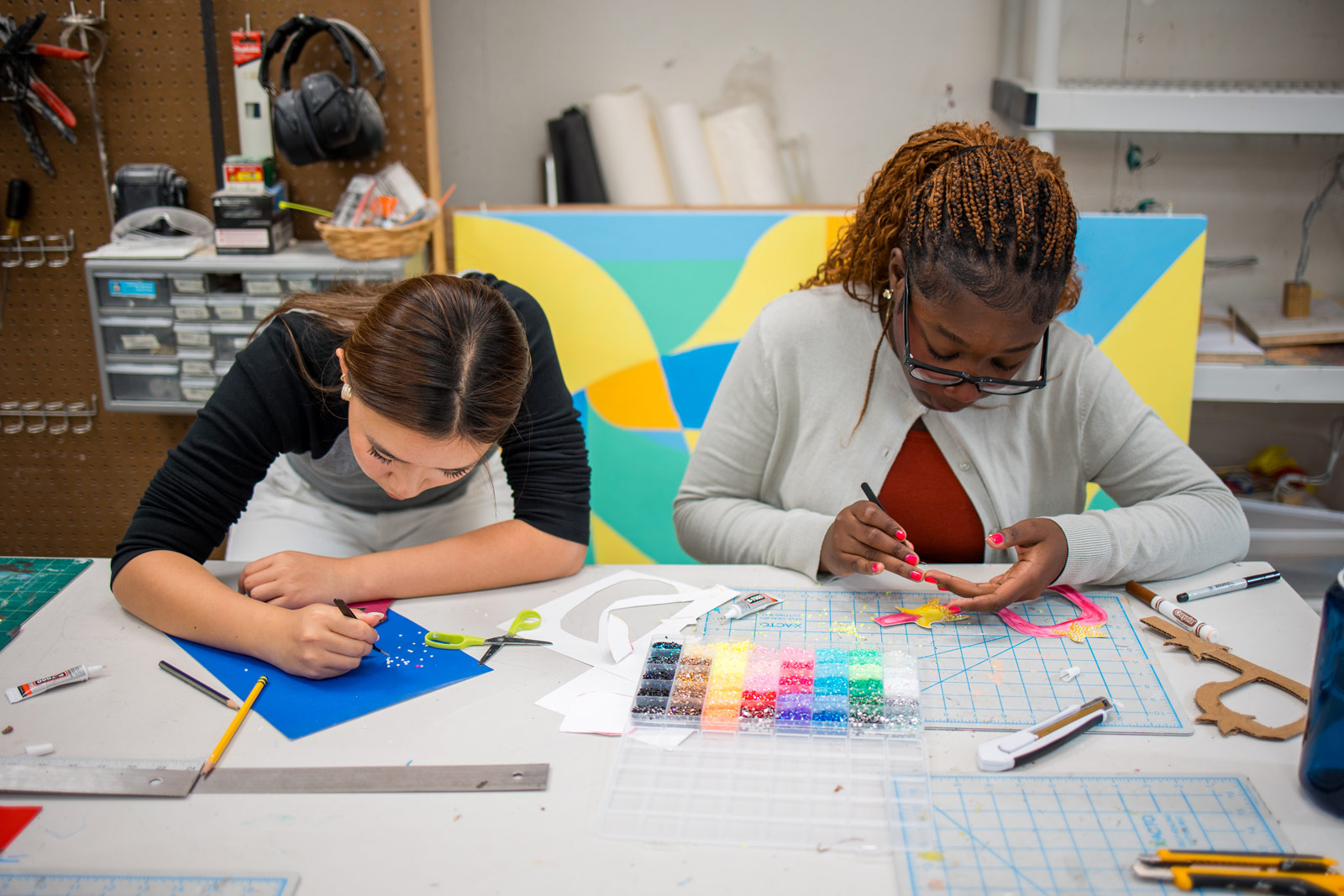 Two students work on art project in classroom