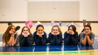 six members of the varsity volleyball team pose for a group picture