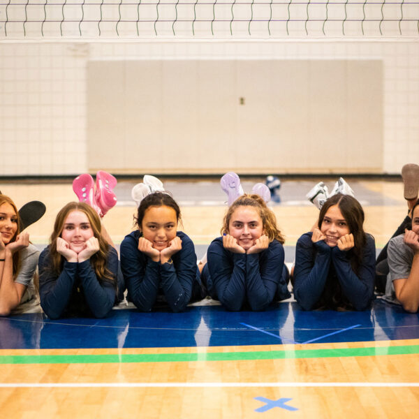 six members of the varsity volleyball team pose for a group picture