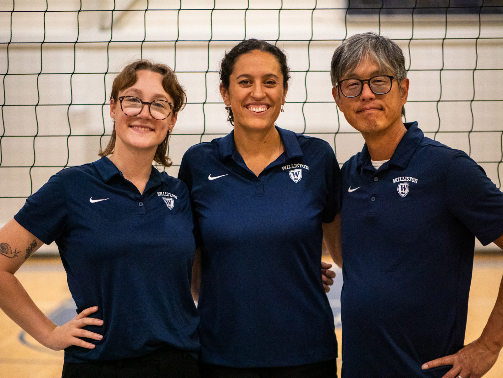 Varsity volleyball coaches pose for group picture